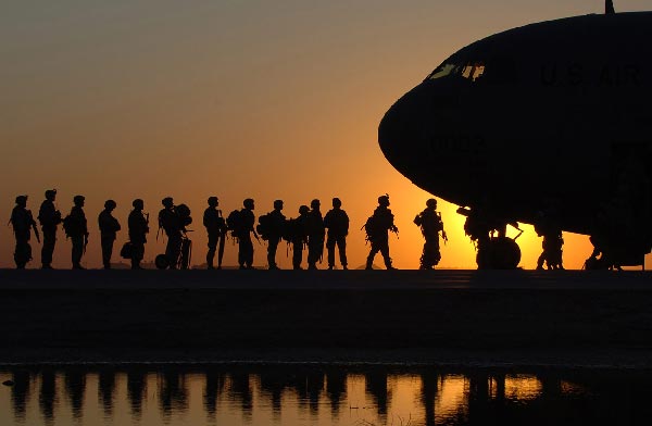 Airmen line up to enter a plane