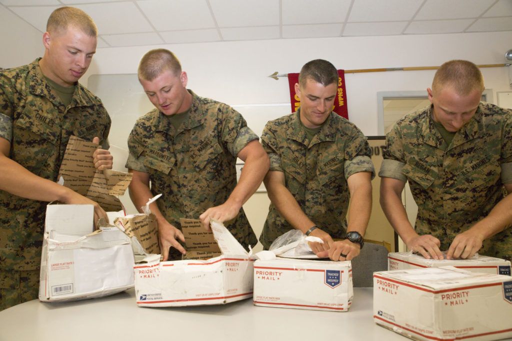 soldiers unboxing care packages
