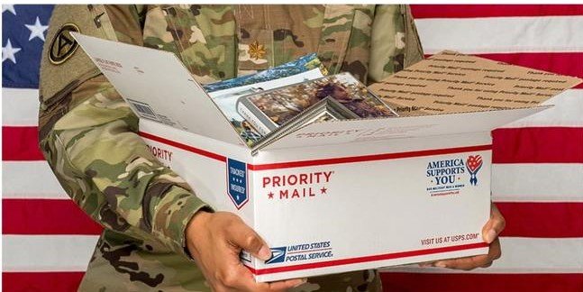 soldier holding a care package
