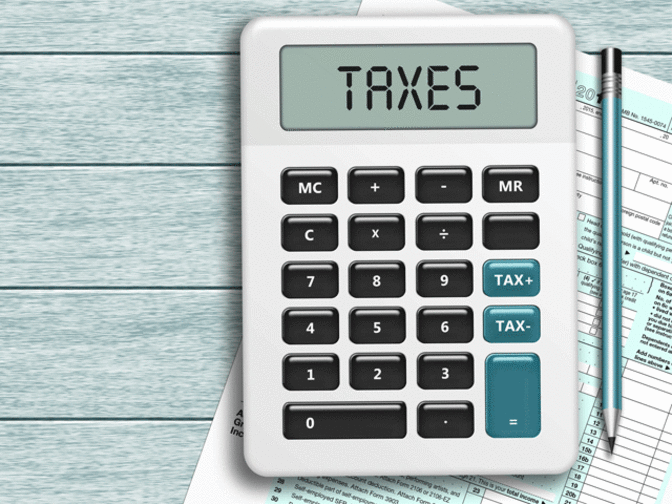 Calculator with taxes written stock image