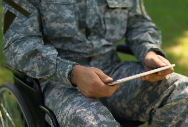 Disabled Veteran in a wheelchair using a tablet