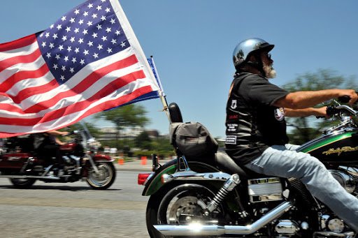 veteran with American Flag flying from his motorcycle