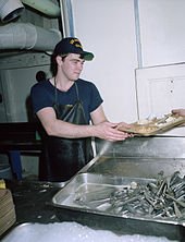 A US Sailor Washes Dishes on Mess Hall / Galley Duty