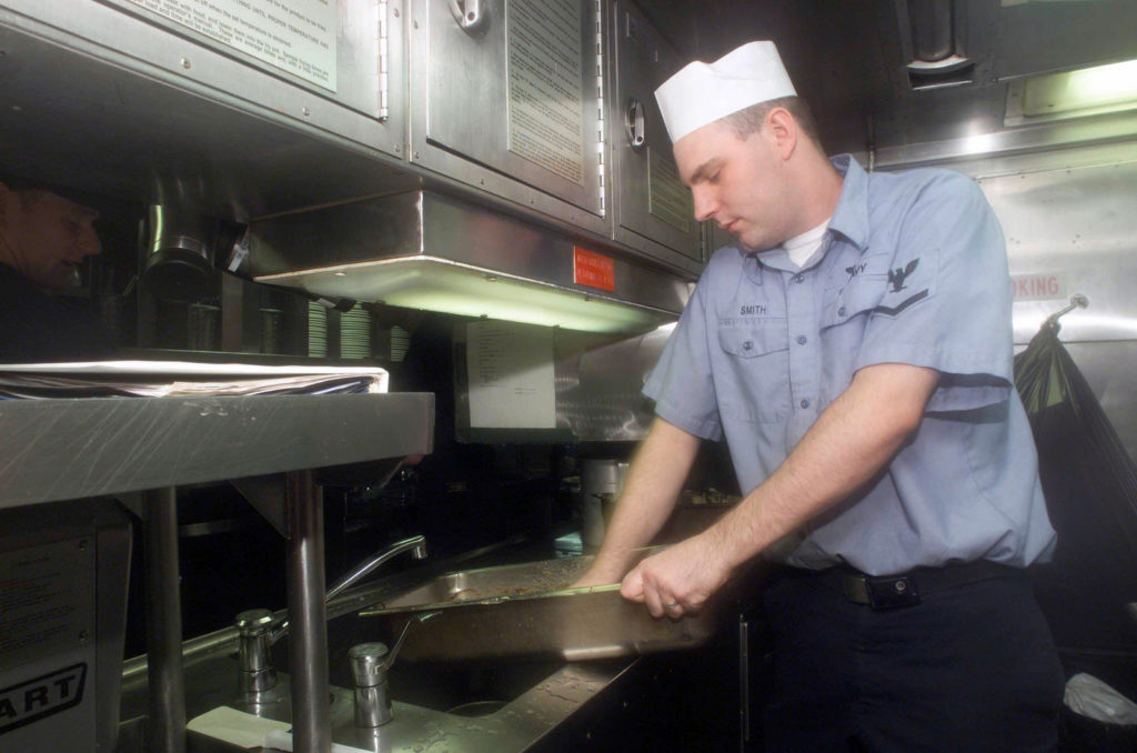 US Navy Sailor Cleaning Mess Hall