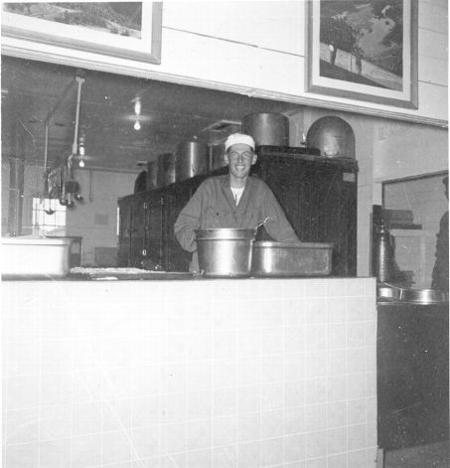 A US Sailor Stands with a Pot & Pan on KP/Kitchen Police Duty