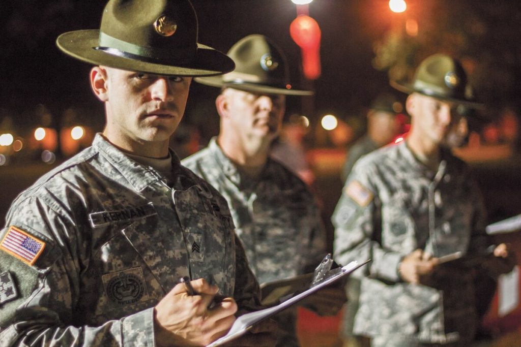 US Army Drill Sergeants Stand In a Line With Clipboards