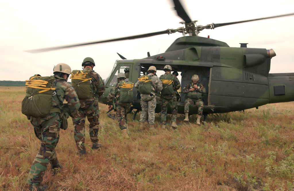 US Army Soldiers get into a helicopter/chopper in a single file line