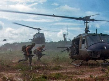 Vietnam War Soldiers Run Towards a UH-1 Huey